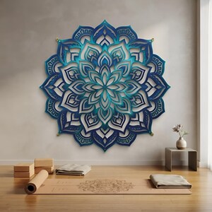 May include: A large, circular, multi-layered wall art piece featuring a symmetrical mandala design in shades of deep navy, royal blue, and bright turquoise. The intricate, laser-cut floral patterns create a sense of depth and dimension.