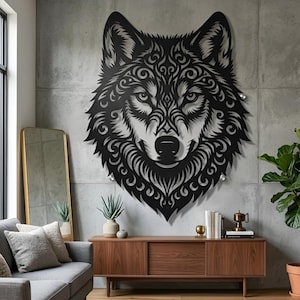 May include: A black metal wolf head wall art piece with detailed swirling patterns. The wolf's face is central, with detailed fur and facial features. The artwork is mounted on a grey concrete wall, adding a modern touch to any room.