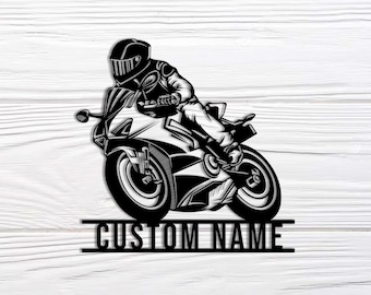 May include: Black and white metal art piece depicting a motorcycle racer on a racing bike. The rider is wearing a helmet and racing gear. The text "CUSTOM NAME" is below the motorcycle.