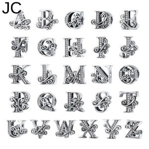 May include: A selection of silver alphabet charms, each featuring an ornate, swirling design and set with tiny, sparkling stones. The letters A to Z are shown, ideal for custom jewellery pieces.