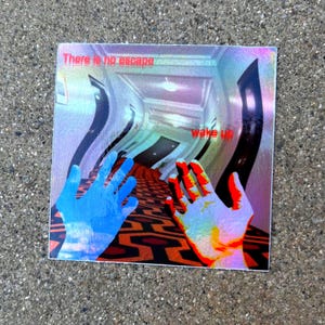 May include: A square holographic sticker featuring a distorted hallway with a geometric carpet pattern. Two hands are visible in the foreground, one blue and one orange. The text "There is no escape" and "wake up" is printed in red.