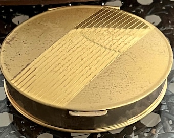 Estuche compacto de polvos de latón tono dorado Volupte vintage de mediados de siglo con espejo