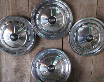 Four 1957 Chevrolet Hubcaps - Item No. 671