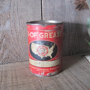 K&ouml;nnte beinhalten: Vintage rote und wei&szlig;e Coop Grease Dose mit einer Karte der Vereinigten Staaten. Auf der Dose steht "Co-op Grease". Die Dose ist leicht verrostet, was ihr ein rustikales Aussehen verleiht.
