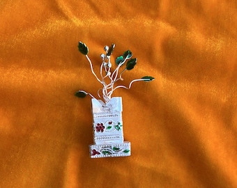 German silver tulsi plant with green leaves and gift bag return gift