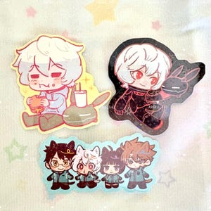 May include: Three die-cut stickers featuring anime-style characters. The top left sticker shows a white-haired character eating a burger next to a drink. The top right sticker depicts a white-haired character with a black rabbit. The bottom sticker shows four characters.
