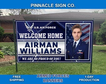 May include: A blue and white welcome home banner with the text "U.S. Air Force", "Welcome Home", "Airman Williams", and "We Are So Proud Of You!" A photo of a man in a military uniform is in the center of the banner.