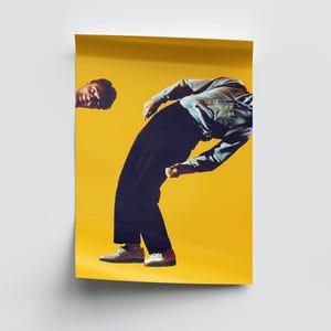 May include: A poster featuring a person in a light blue button-down shirt and dark trousers bending backward against a solid yellow background. A separate, smaller image of a face looking toward the person is positioned in the upper left corner.