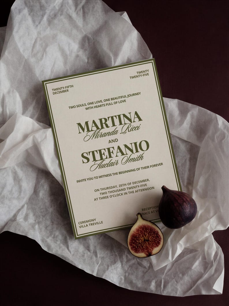 A cream and olive green wedding invitation card rests on white tissue paper with a whole fig and a sliced fig.