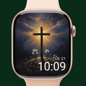 May include: A rose gold smartwatch displaying a digital painting of a cross on a hill with a bright sky. The time is 10:09, and the date is Tuesday, the 21st.