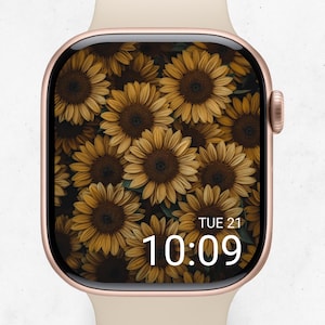 Könnte beinhalten: Eine roségoldene Smartwatch mit einem Sonnenblumen-Design auf dem Bildschirm. Das Zifferblatt zeigt Datum und Uhrzeit an, mit einem hellfarbenen Armband. Der Bildschirm zeigt ein Feld mit Sonnenblumen.