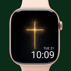 May include: A rose gold smartwatch with a black screen displaying a golden cross design. The time is 10:09, and the date is Tuesday, the 21st. The watch has a light pink band.