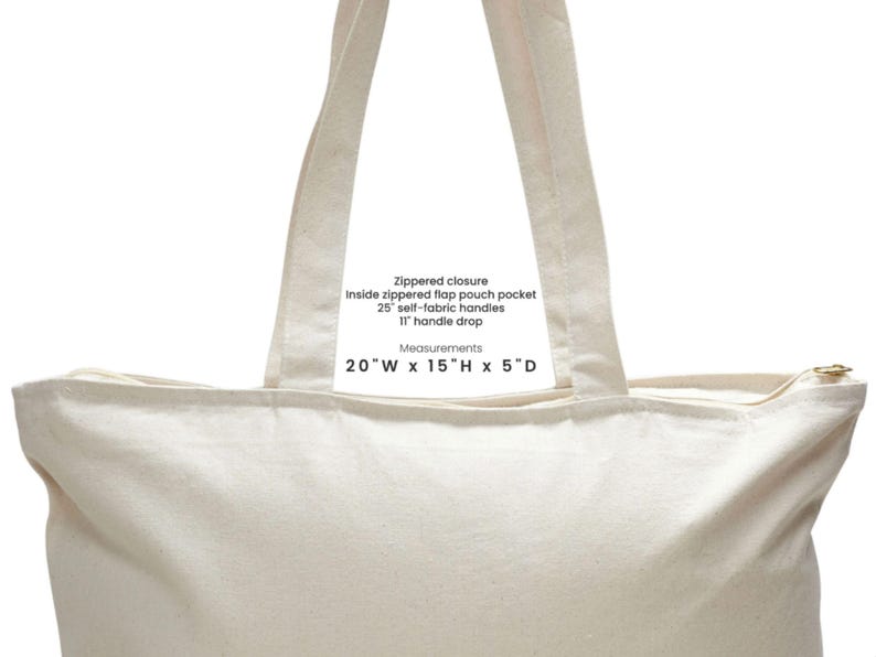 May include: Cream-colored tote bag with a zippered closure, 25-inch self-fabric handles, and an 11-inch handle drop. Features an inside zippered flap pouch pocket. Bag dimensions are 20"W x 15"H x 5"D.