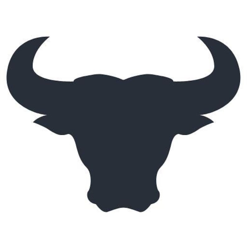 May include: A dark charcoal gray silhouette of a bull head featuring prominent, curved horns extending outward and upward, with a defined snout and pointed ears, presented as a solid graphic icon against a plain white background.