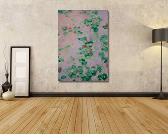 May include: A vertical rectangular canvas wall art piece featuring an impressionist-style painting of green lily pads and small red flowers floating on a soft, light purple water surface, displayed as a framed print on a textured wall.