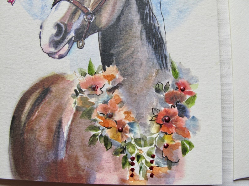 May include: Watercolor painting of a brown horse with a floral garland around its neck. The flowers are in shades of orange, red, and pink.