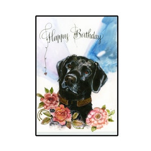 May include: A watercolor painting of a black Labrador Retriever with a brown leather collar, surrounded by pink and orange roses. The text "Happy Birthday" is written in cursive at the top of the card.