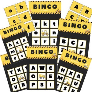 May include: A set of printable alphabet bingo cards featuring construction vehicles. The cards have a black background with yellow and black stripes. The letters are in white and the vehicles are in yellow, black, and orange.