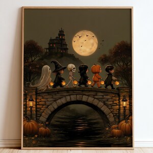 May include: A framed wall art print depicting a group of six children in Halloween costumes, including a ghost, witch, skeleton, and pumpkin, walking across a stone bridge at night under a full moon with a haunted house in the background.