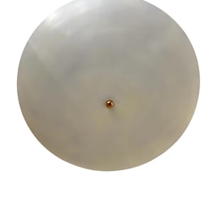 May include: A round, off-white ceiling light fixture with a copper-colored central accent. The light has a smooth, matte finish and a simple, minimalist design. The fixture is suitable for various interior design styles.