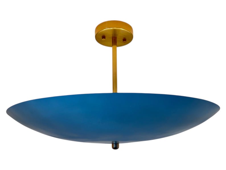 May include: A modern ceiling light fixture with a blue, bowl-shaped shade. The fixture has a gold-colored stem and ceiling mount. The shade is a deep blue color. The light fixture is designed to be mounted on a ceiling.