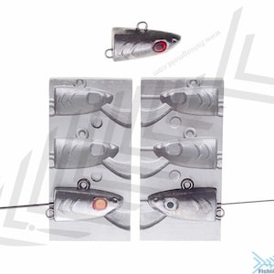 May include: A mold for making fishing lures. The mold is made of metal and has six cavities. Each cavity is shaped like a fish. The mold is shown with a finished lure, which is silver with a red eye.
