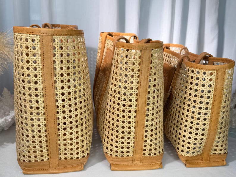 Three woven baskets with a light brown color and a pattern of small holes arranged in a row.