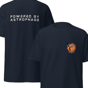 May include: Navy blue t-shirts with white text. One shirt reads "POWERED BY ASTROPHAGE" on the back. The front of the other shirt has a graphic with the words "HAIL MARY EARTH" and a rocket ship design.