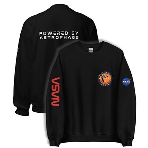 May include: Black sweatshirt with the text "POWERED BY ASTROPHAGE" on the back. The front features a "HAIL MARY EARTH" patch and a NASA logo. The left sleeve has "VSVN" in red.