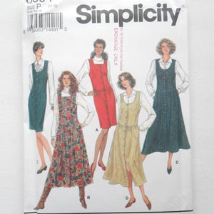 May include: Simplicity sewing pattern 8604 featuring five dress designs. The pattern envelope is white with the Simplicity logo and the text "EXCHANGE ONLY". The dresses include a floral print, solid colors, and button-down styles.