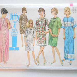 May include: Vintage Simplicity sewing pattern envelope featuring illustrations of robes in various styles and colors. The envelope includes the text "Jiffy robe" and "4 main pattern pieces". The pattern is size 14, bust 34 inches.