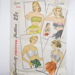 May include: Vintage Simplicity sewing pattern for a strapless top with a bow detail. The pattern is printed on a white paper with a black and white illustration of four women wearing the top. The pattern number is 2020 and the price is 25 cents.