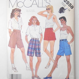 May include: A vintage McCall's sewing pattern packet featuring illustrations of shorts in various styles. The packet includes the text "McCall's", "Tops not included", and the pattern number "2558". The illustrations depict shorts in pink, plaid, red, and blue.