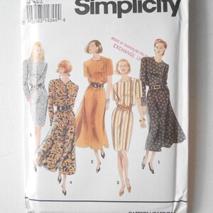 May include: A vintage Simplicity sewing pattern packet featuring illustrations of five different dress designs. The packet is white with the Simplicity logo and pattern number 8529. The designs include dresses with various sleeve lengths, patterns, and belt details.