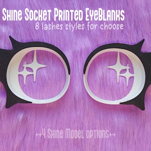 Puede incluir: Un par de ojos en blanco en blanco y negro con detalles en forma de estrella, diseñados para manualidades. El texto de la imagen dice "Shine Socket Printed EyeBlanks" y "8 estilos de pestañas para elegir". El fondo es una superficie morada difusa.