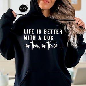 May include: Black hooded sweatshirt with the text "LIFE IS BETTER WITH A DOG -or two, or three..." in white.