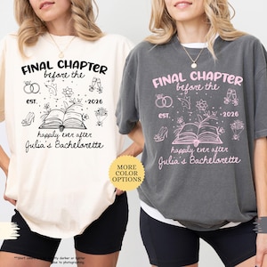May include: Ivory and pepper-colored t-shirts with the text "Final Chapter before the est. 2026 happily ever after Julia's Bachelorette" in black and pink. The shirts feature illustrations of rings, flowers, shoes, champagne glasses, and a book.
