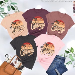 May include: Five t-shirts in different colors with a sunset graphic and the text "California" in a retro font.