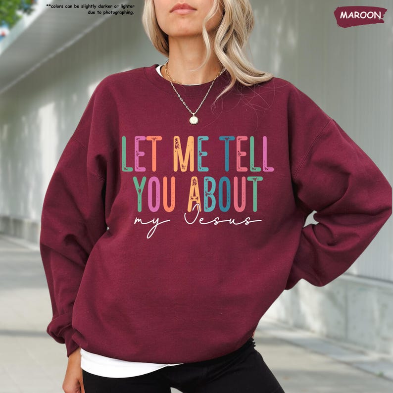 May include: A maroon sweatshirt with the text "LET ME TELL YOU ABOUT my Jesus" in rainbow colors.