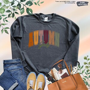 a gray shirt with the word autumn printed on it