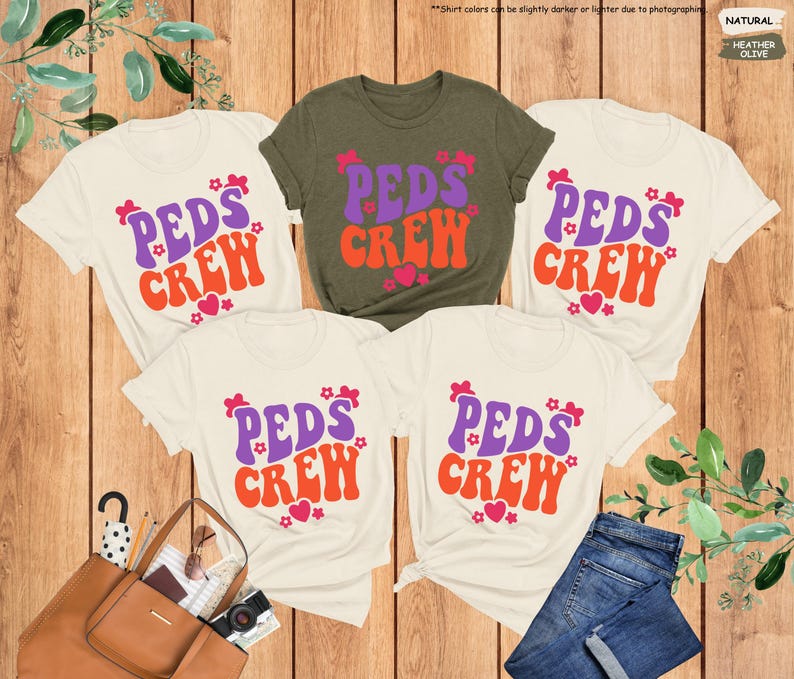 May include: Four white t-shirts with the text "PEDS CREW" in a retro font with purple and orange lettering and pink hearts. The shirts are arranged in a square shape with a green t-shirt in the center.