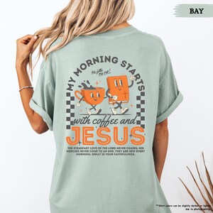 May include: A light blue t-shirt with a graphic of a coffee cup and a bible dancing with the text "My Morning Starts with Coffee and Jesus". The text "He fills my cup!" is above the graphic. The text "The steadfast love of the Lord never ceases: His mercies never come to an end; they are new every morning: Great is your faithfulness." is below the graphic.