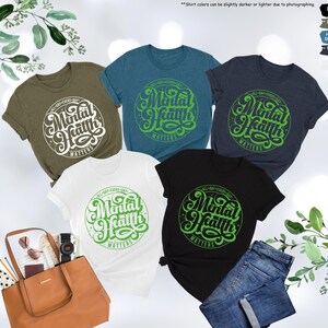 May include: Five t-shirts in different colors with the text "Mental Health Matters" in a green and white design. The text is in a circle with a starburst pattern.