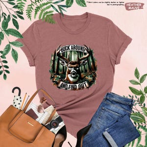a women's t - shirt with a picture of a deer in the woods