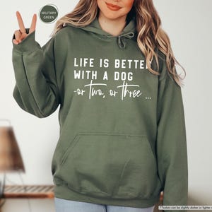 May include: A green hooded sweatshirt with the text "Life is better with a dog - or two, or three..." printed in white on the front.