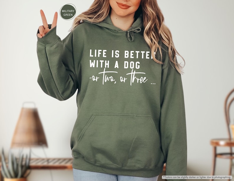 May include: A green hooded sweatshirt with the text "Life is better with a dog - or two, or three..." printed in white on the front.