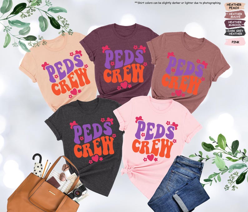 May include: Five t-shirts in different colors with the text "PEDS CREW" in a retro font. The text is in purple, orange, and pink. The shirts are a heather peach, heather mauve, heather maroon, dark grey heather, and pink.