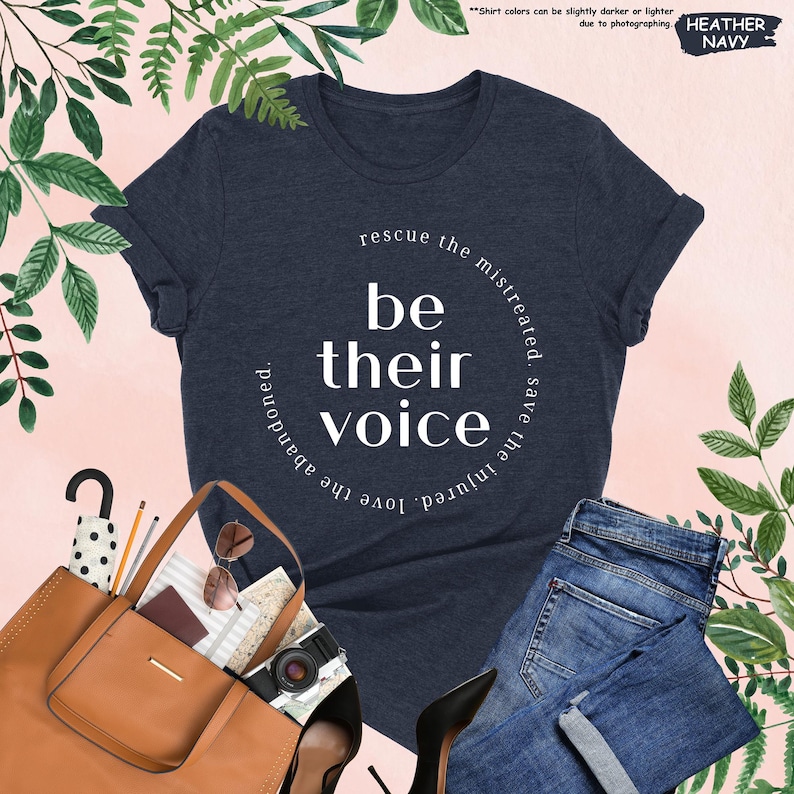 a t - shirt that says be their voice next to a pair of jeans and