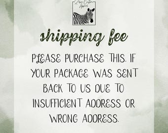 May include: White background with text that reads "shipping fee" in a decorative font. Below, the text continues: "PLEASE PURCHASE THIS. IF YOUR PACKAGE WAS SENT BACK TO US DUE TO INSUFFICIENT ADDRESS OR WRONG ADDRESS."