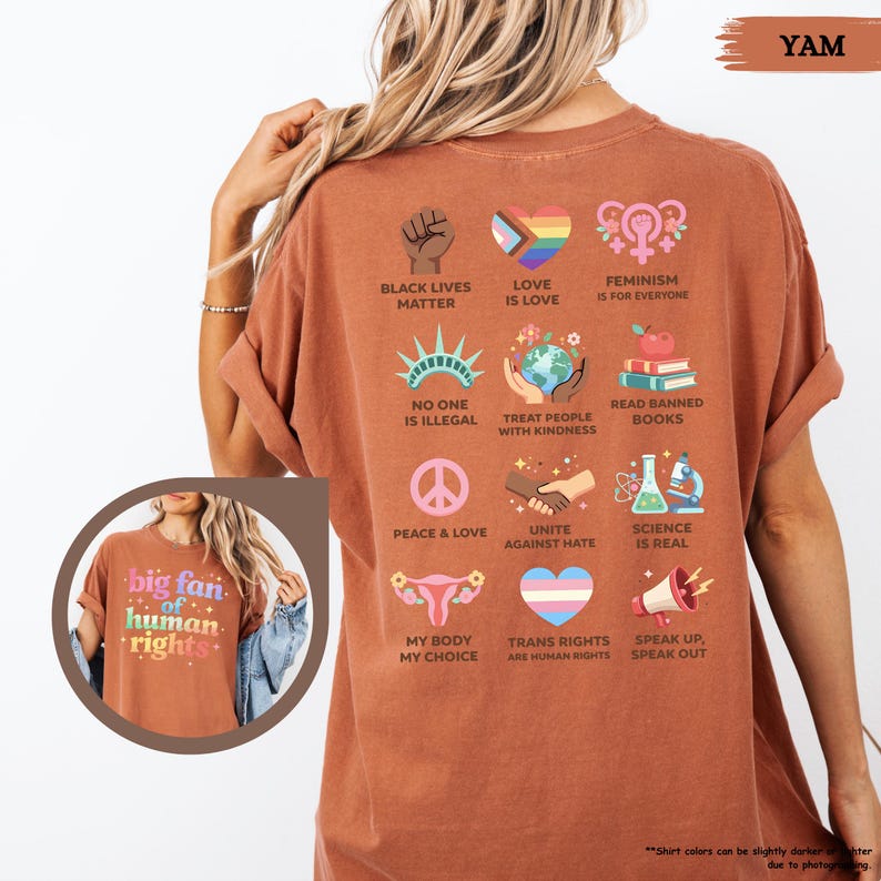 May include: A terracotta-colored t-shirt with various graphic designs and text. The back of the shirt features icons and phrases such as "Black Lives Matter," "Love is Love," and "Science is Real." The front of the shirt in the inset image says "big fan of human rights."
